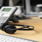 Analog phone and headphones depecting a BPO call center