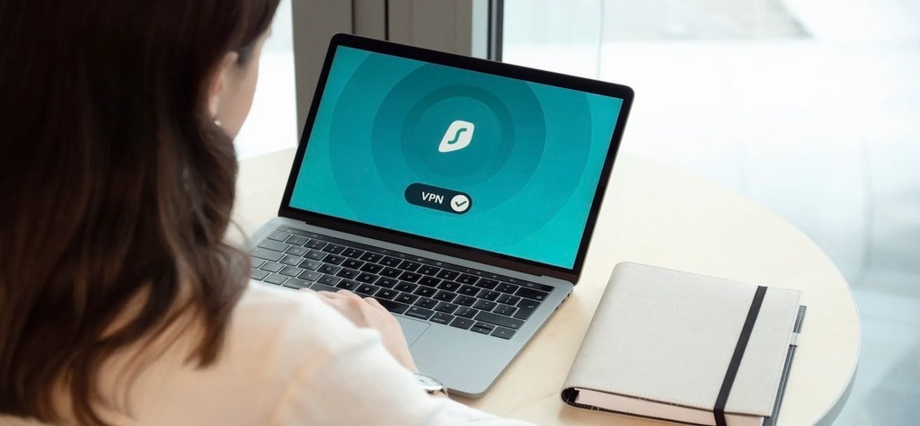 a person using surfshark vpn on a laptop