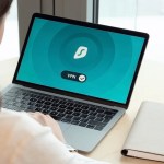 a person using surfshark vpn on a laptop