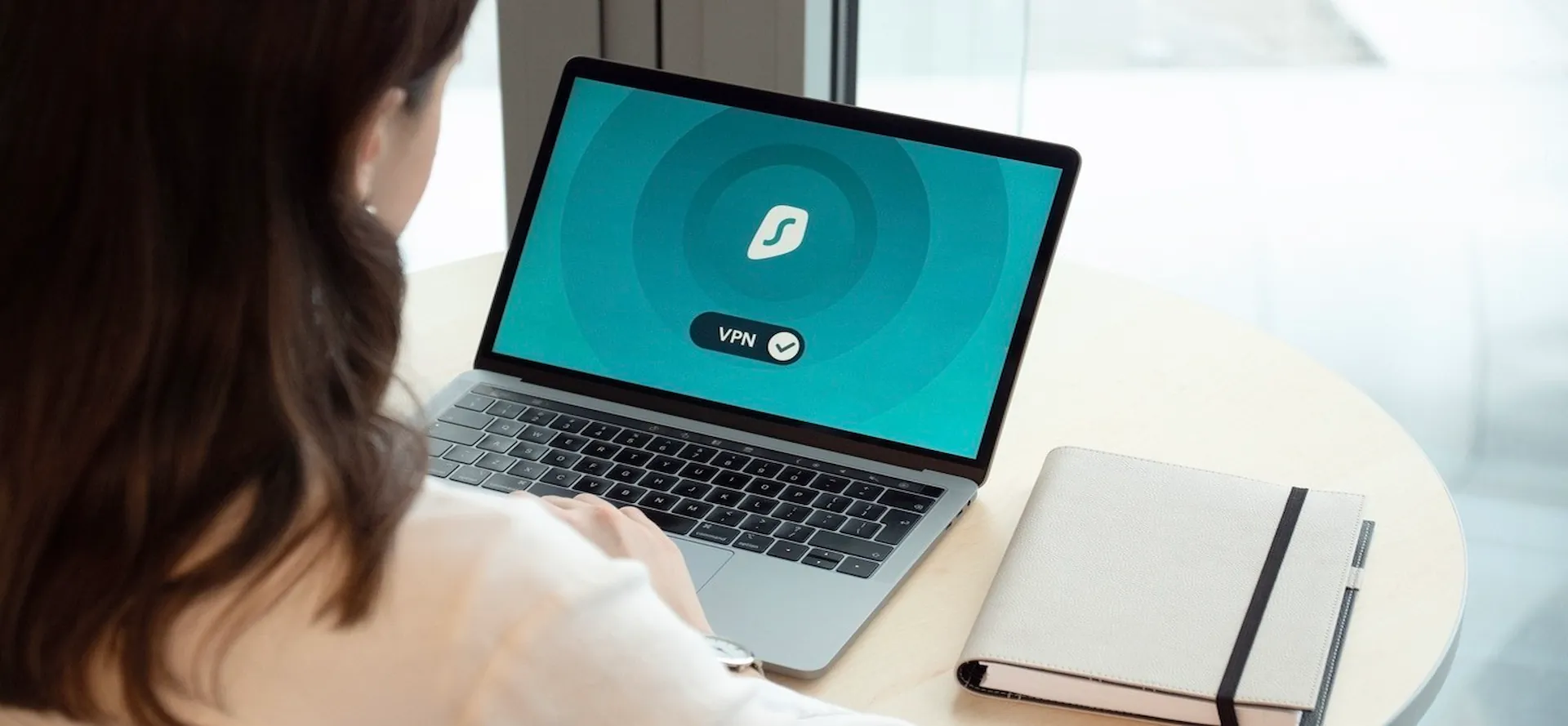 a person using surfshark vpn on a laptop