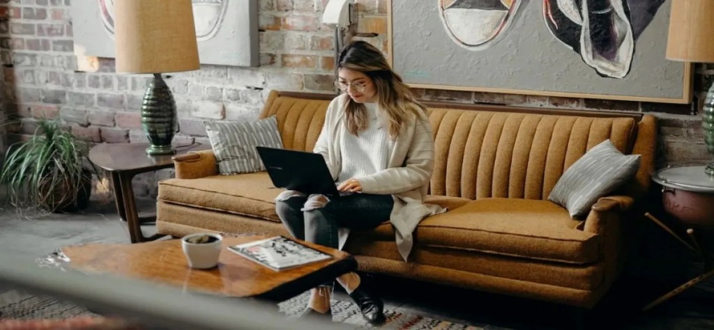 Woman doing SEO-work on a office sofa.
