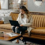 Woman doing SEO-work on a office sofa.