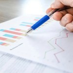 A person insecting graphs and statistics about market research