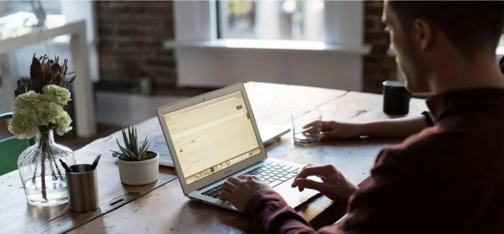 Person inspecting outsourced sales report on a computer.