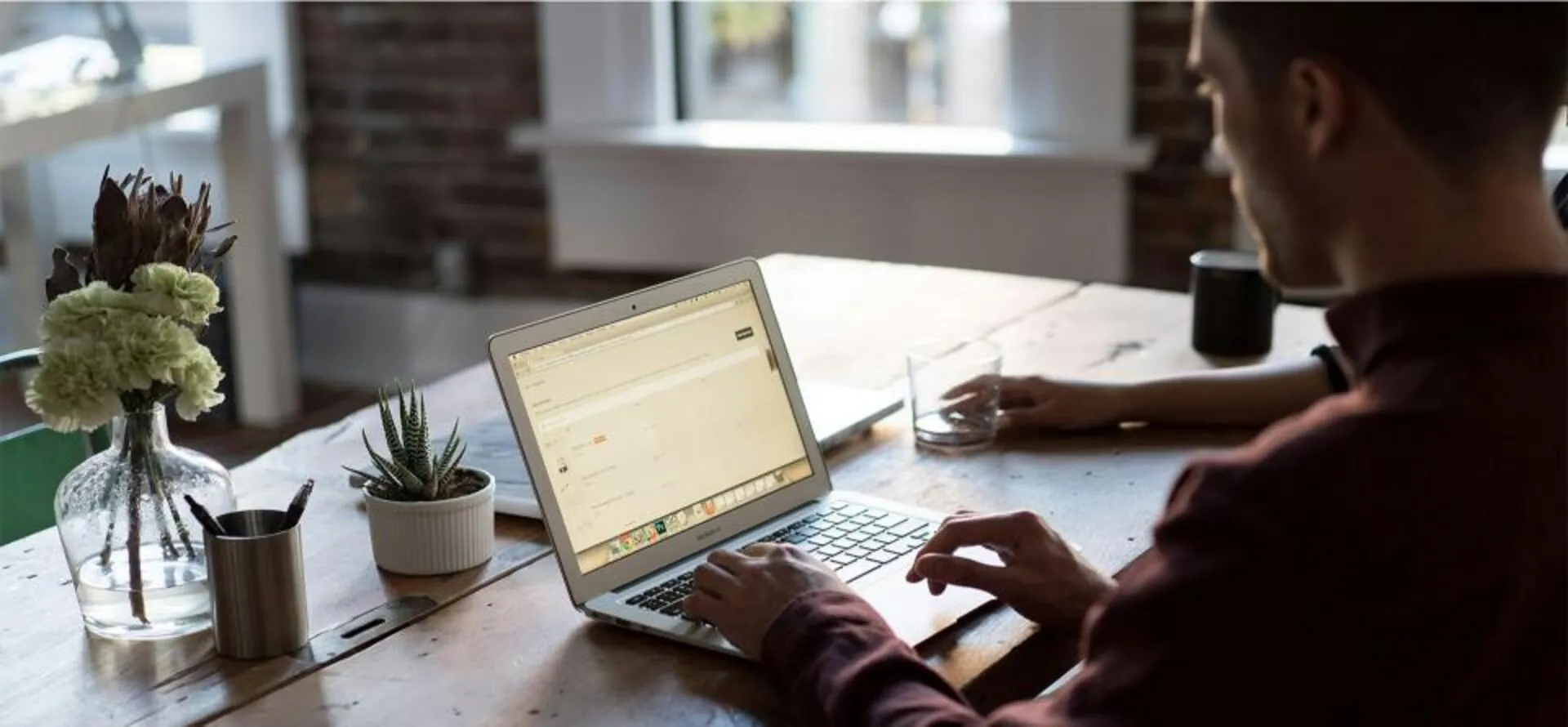 Person inspecting outsourced sales report on a computer.