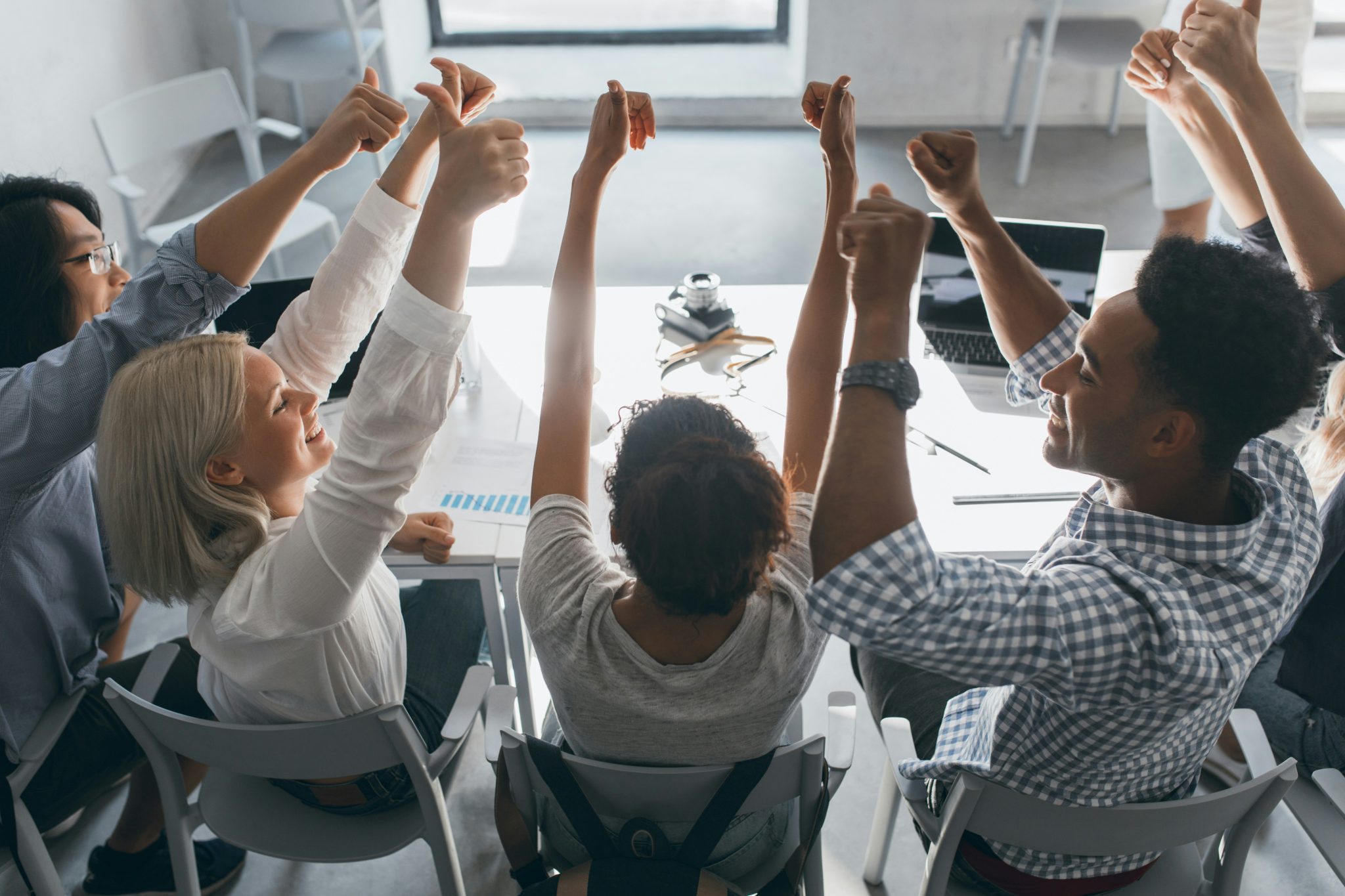Team celebrating success during a collaborative work meeting