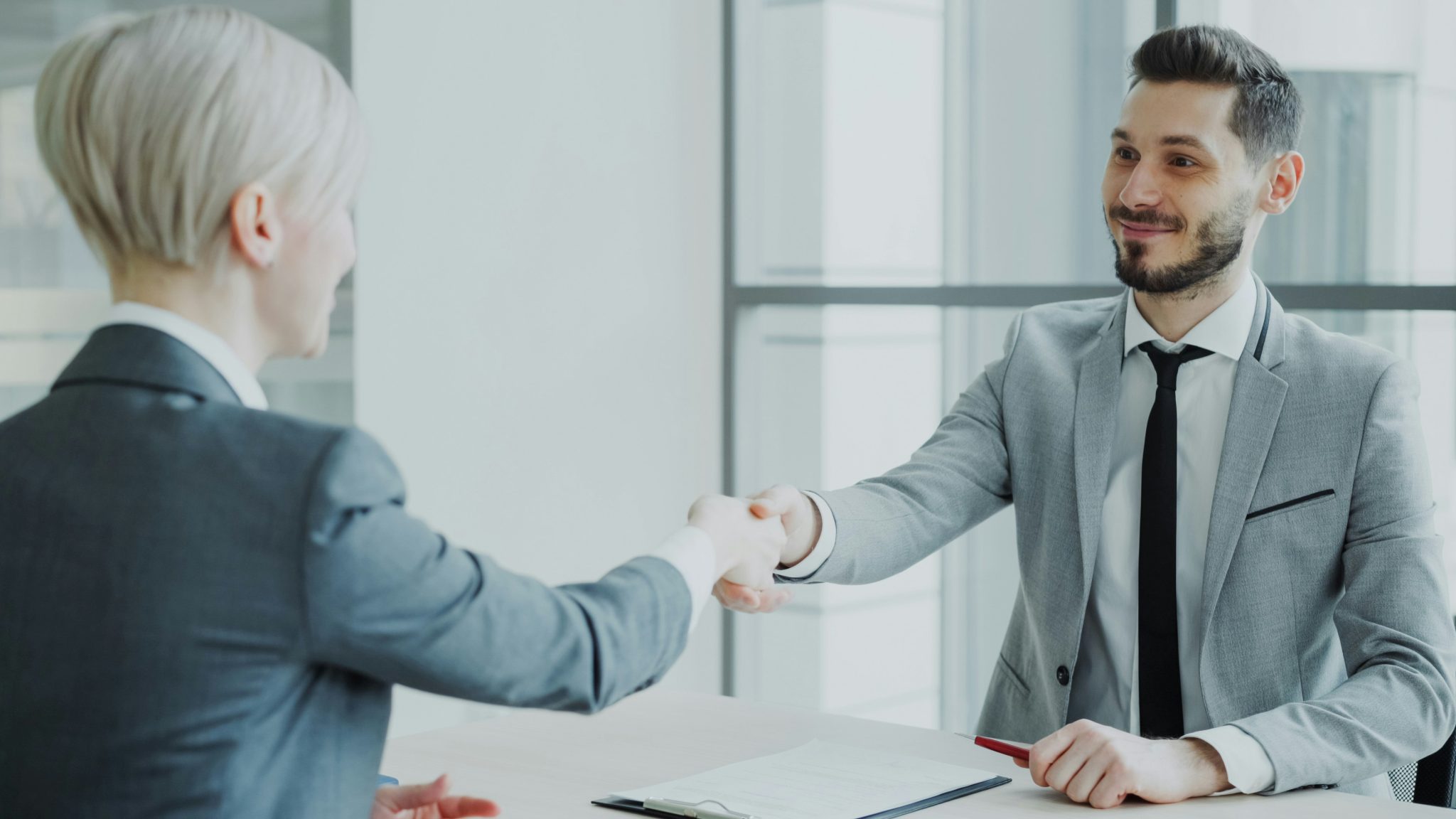 Business professionals shaking hands during a business support partnership meeting