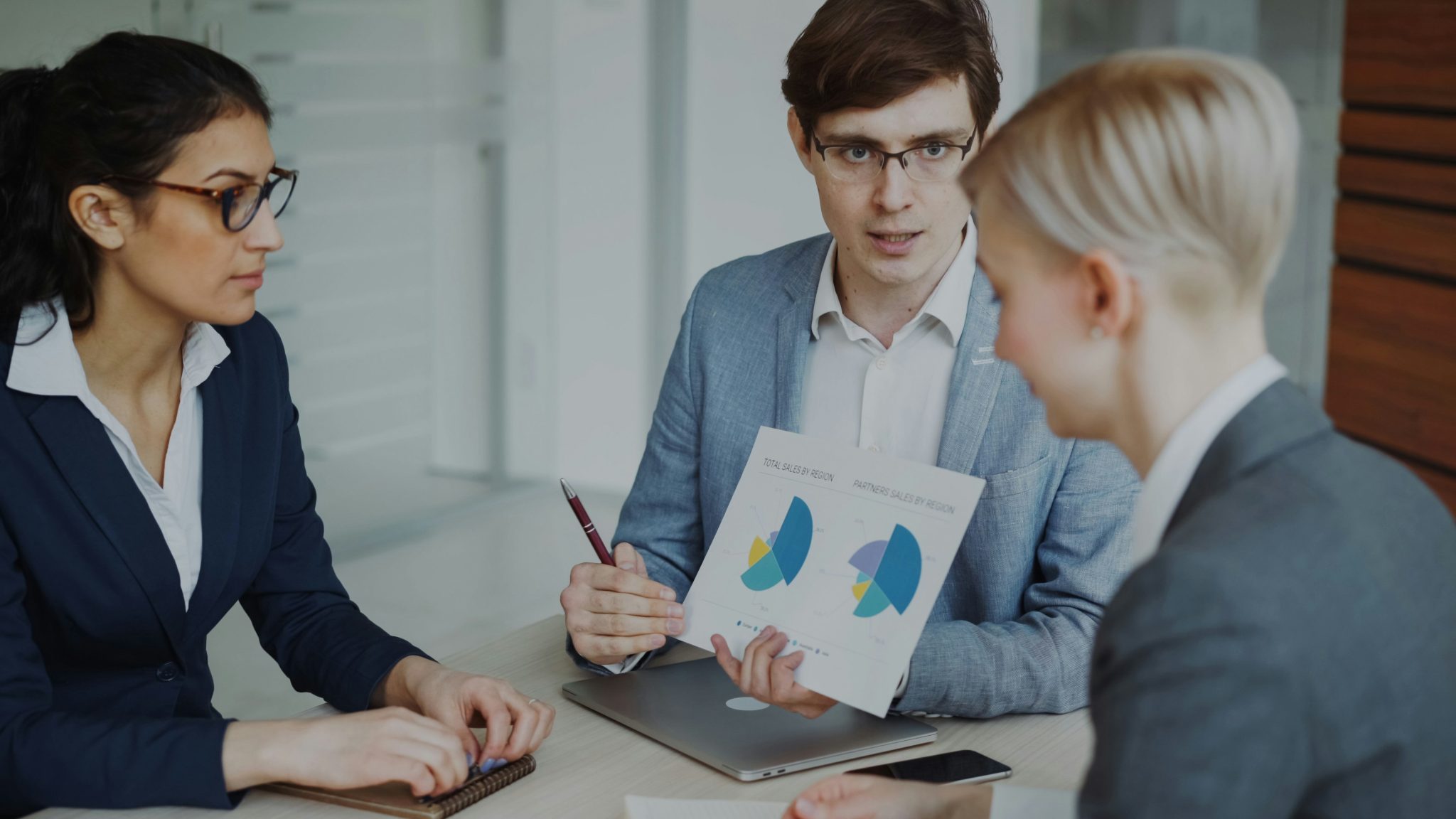 Business professionals reviewing competitor analysis data and market research insights during a strategy meeting