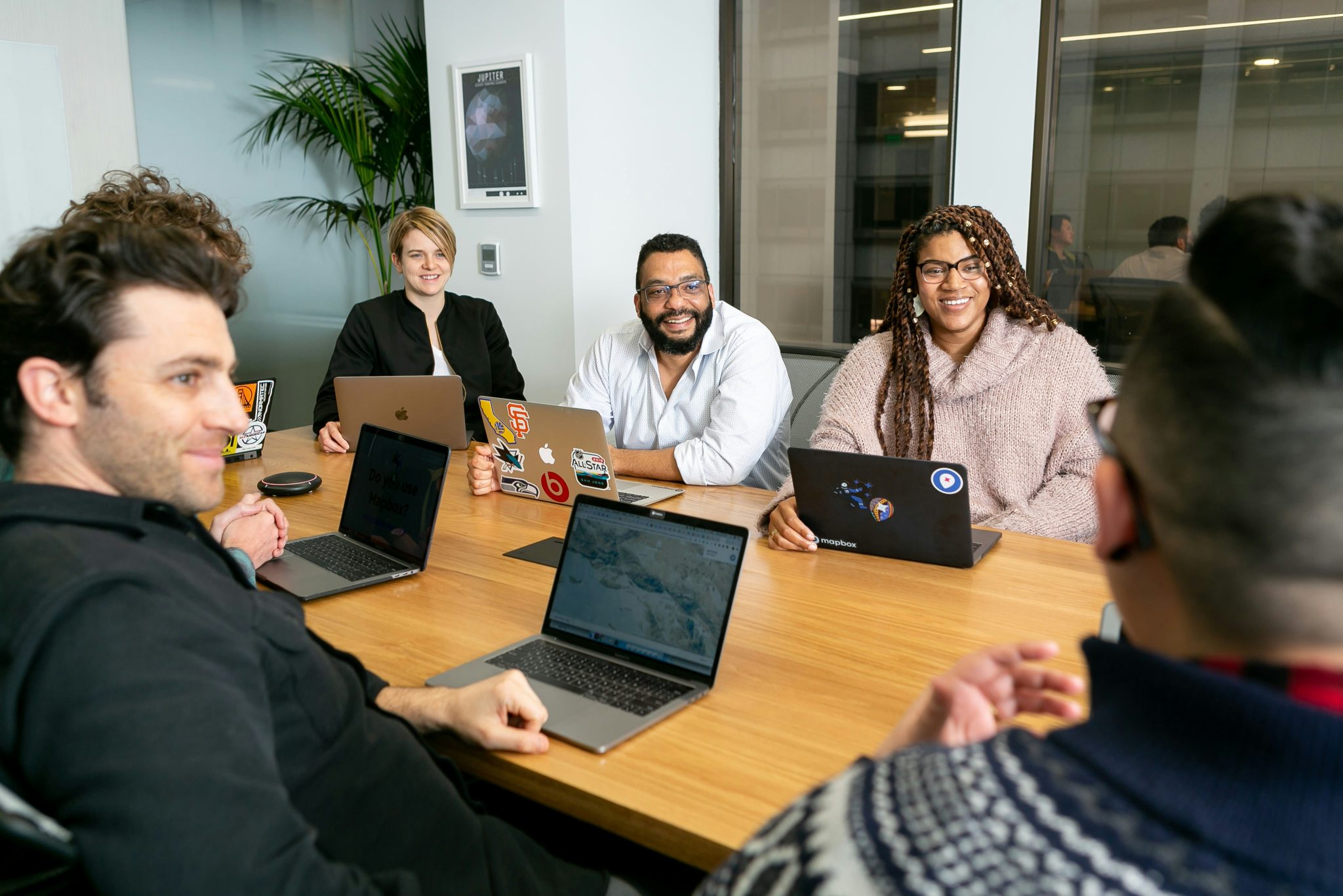 Multicultural team meeting discussing multilingual recruitment and international hiring strategies