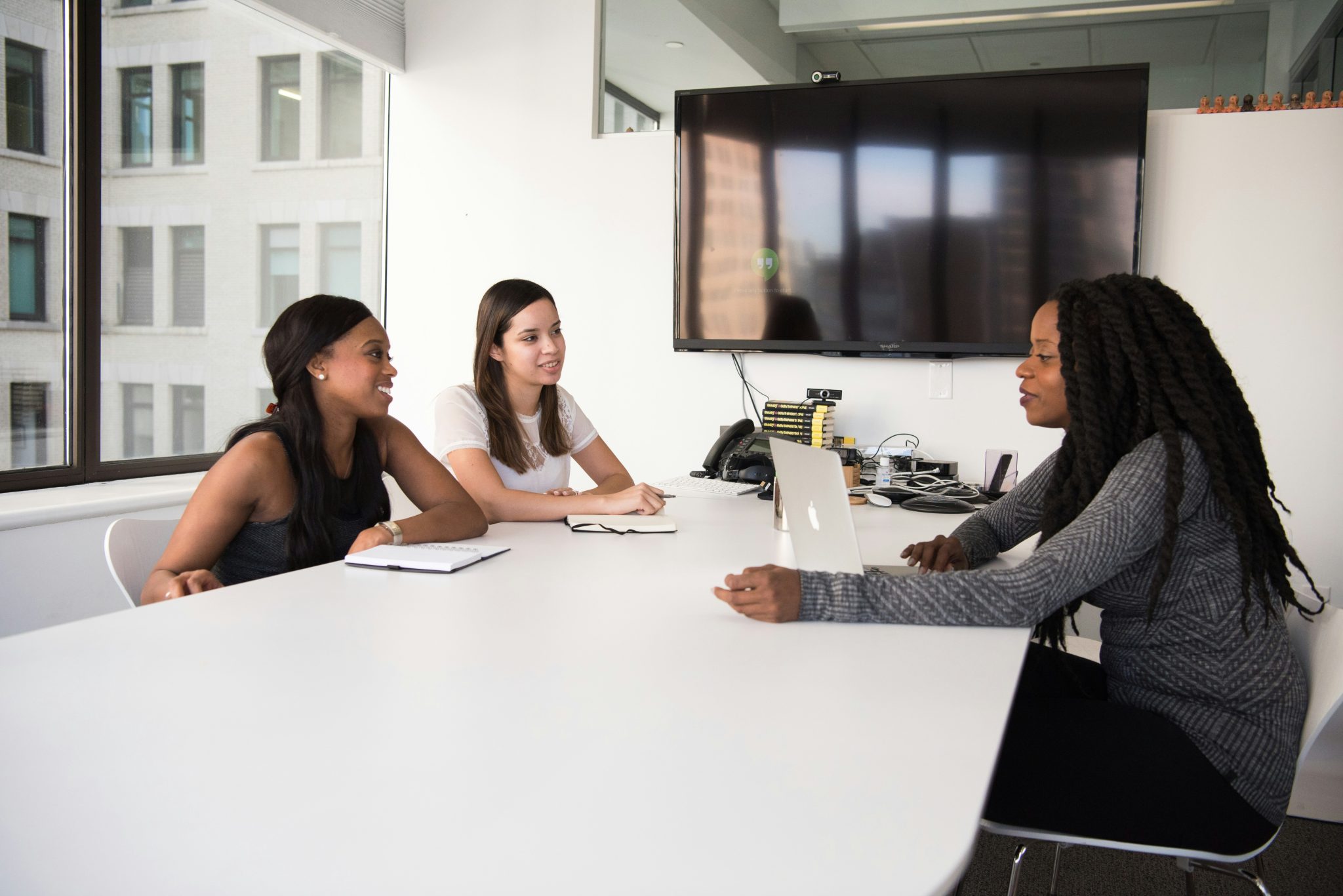 HR professionals discussing recruitment, employee support, and workforce management during a business meeting.