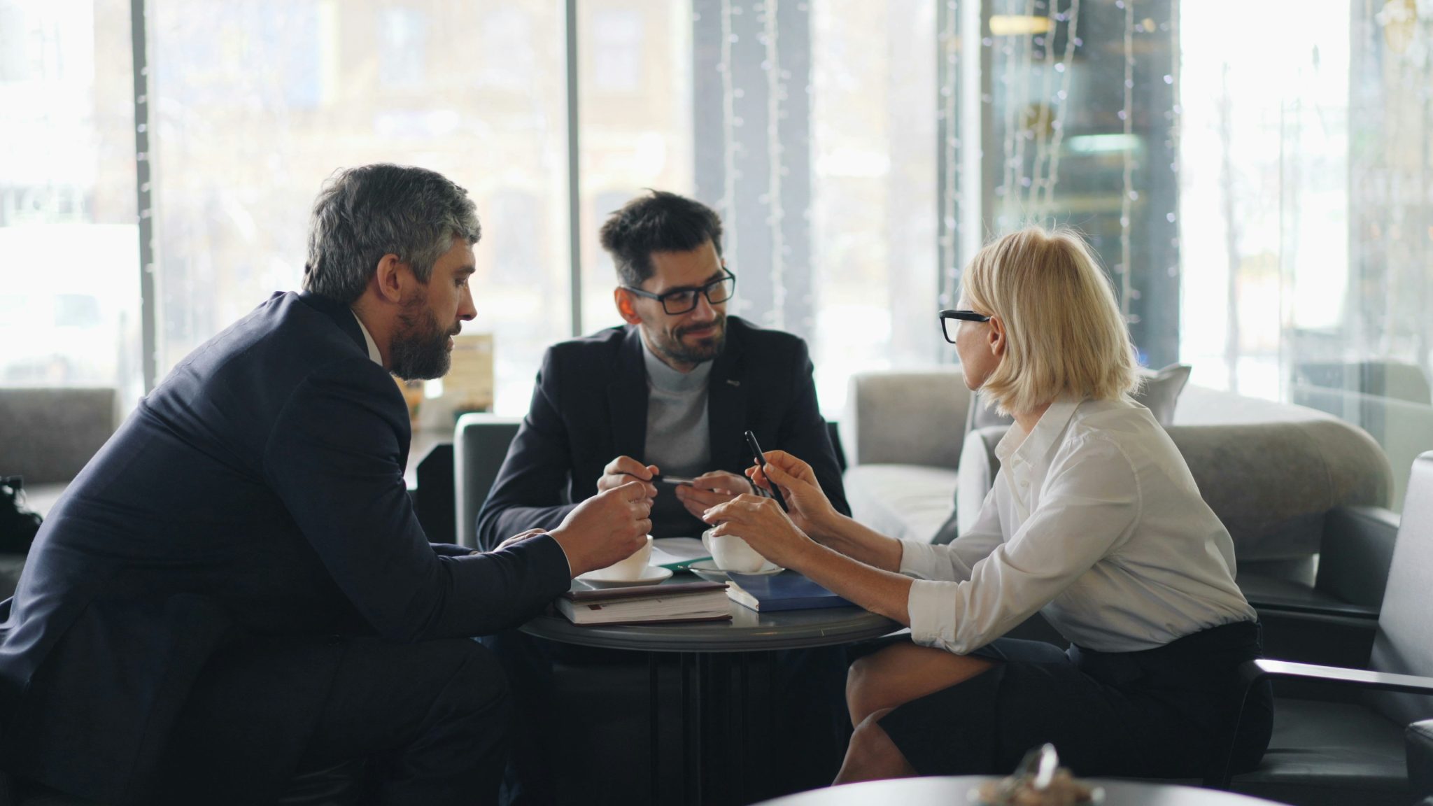 Business professionals discussing strategy and outsourcing solutions in a meeting